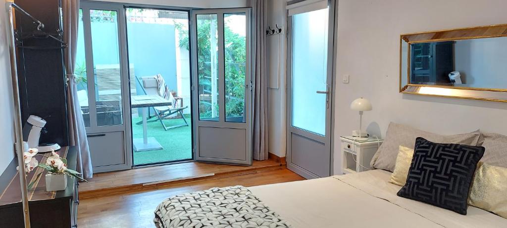a bedroom with a bed and a sliding glass door at Villa Angelus in Nice