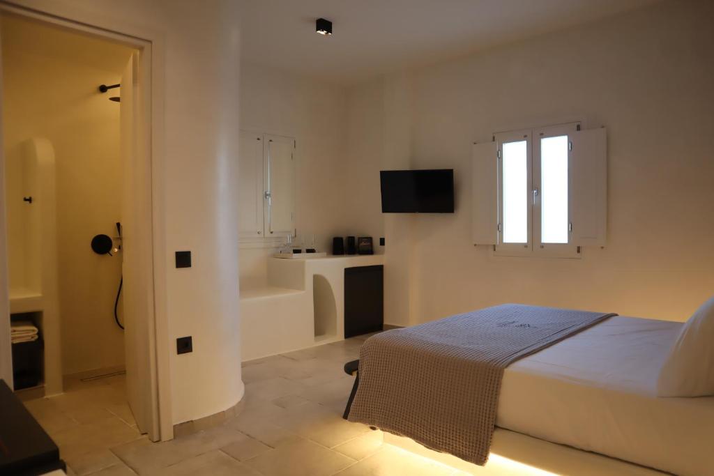Postel nebo postele na pokoji v ubytování Santozen Suites