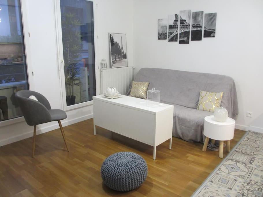 a living room with a couch and a chair at RER C Les Grésillons NEAR PARIS in Asnières-sur-Seine