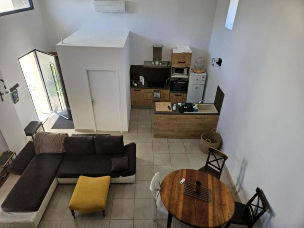 a living room with a couch and a table at La Bergerie in Narbonne
