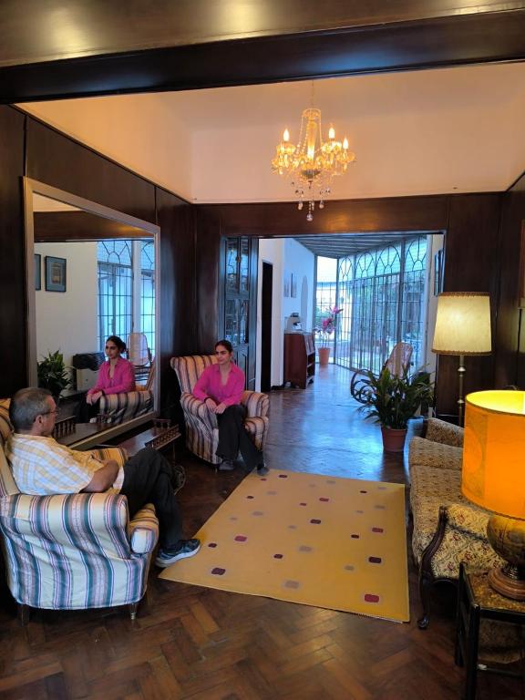 a group of people sitting in a living room at La Teresita Hotel Boutique in Salta