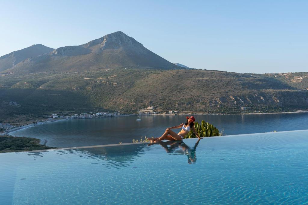 a woman is on the water on a lake at Manifest Boutique Hotel in Oitylo