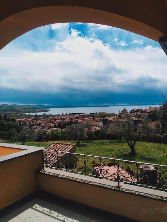 a balcony with a view of a city at Bolsena Cento20 - Rooms & Relax in Bolsena