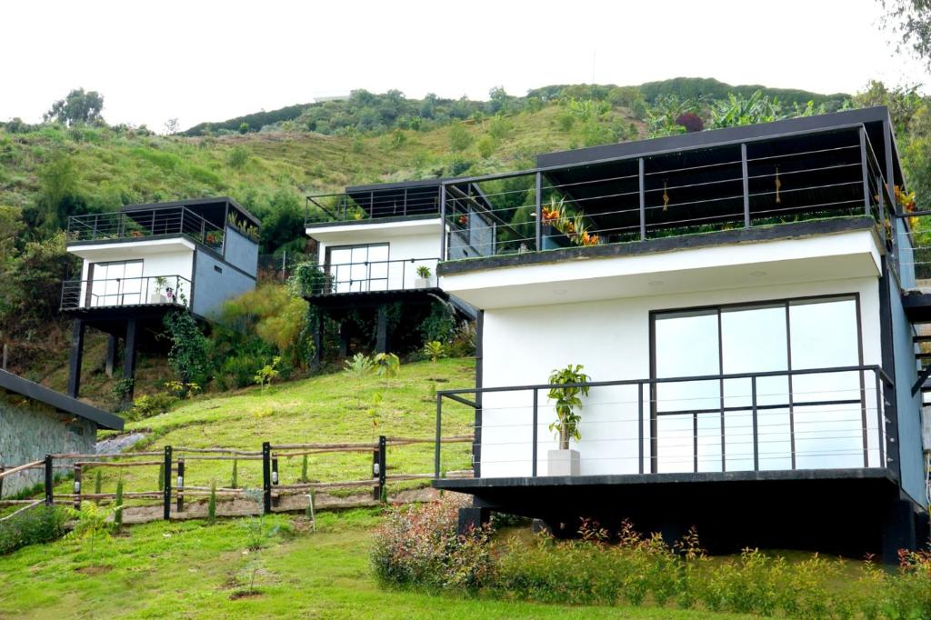 a white house on top of a hill at Hotel Onsen in Guatapé