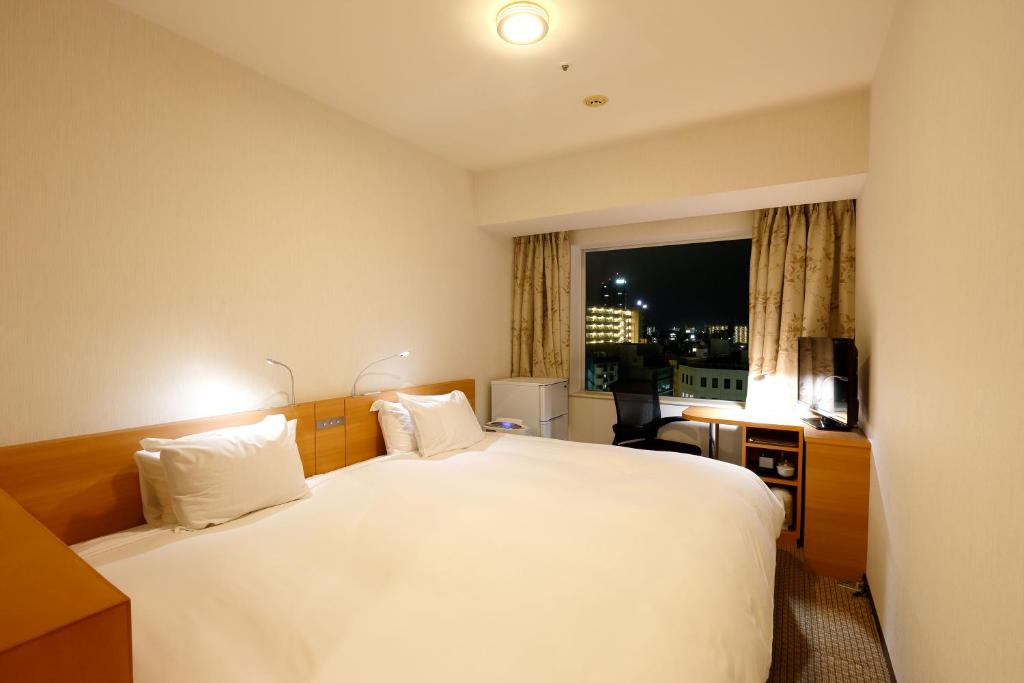 Postel nebo postele na pokoji v ubytování Keisei Hotel Miramare
