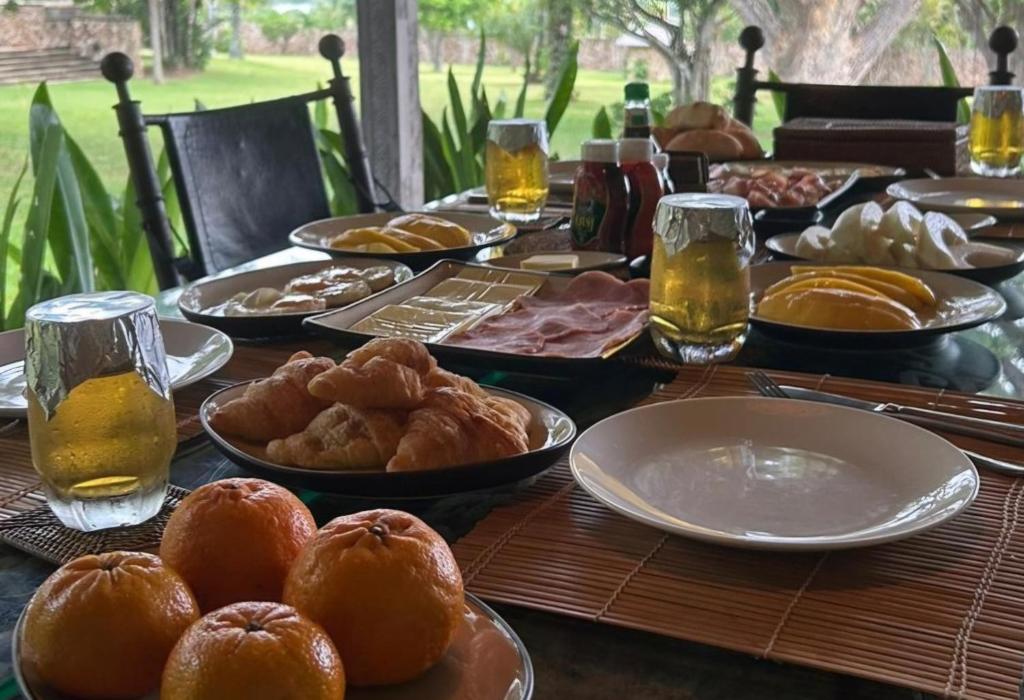 a table topped with plates of food and drinks at Tropical villa in the Bangsare hills near Pattaya in Bang Sare