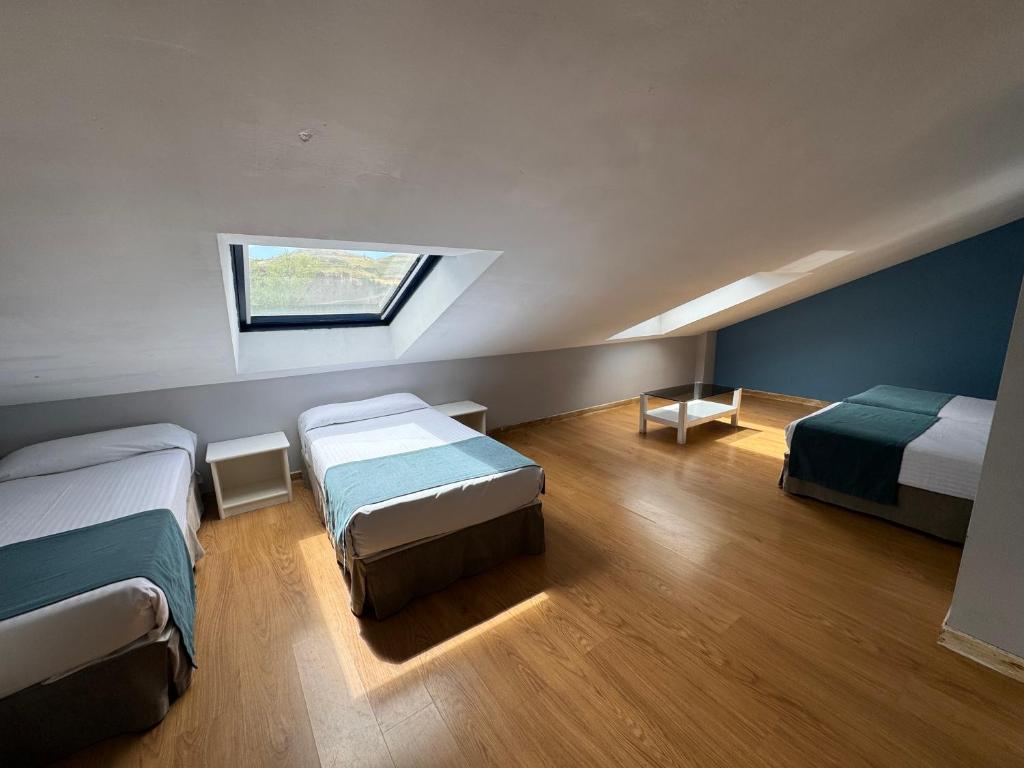 Postel nebo postele na pokoji v ubytování Hotel Jakue