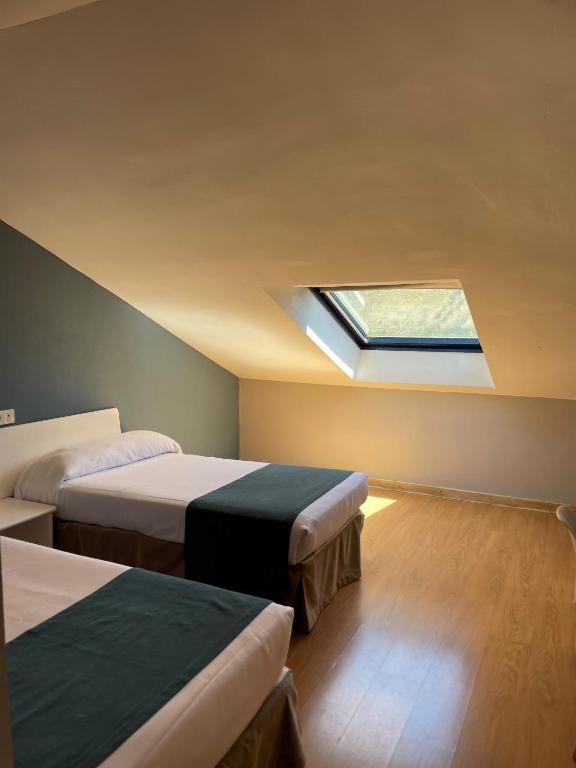 Postel nebo postele na pokoji v ubytování Hotel Jakue