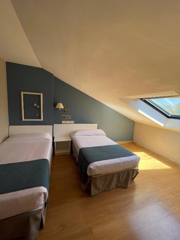 Postel nebo postele na pokoji v ubytování Hotel Jakue