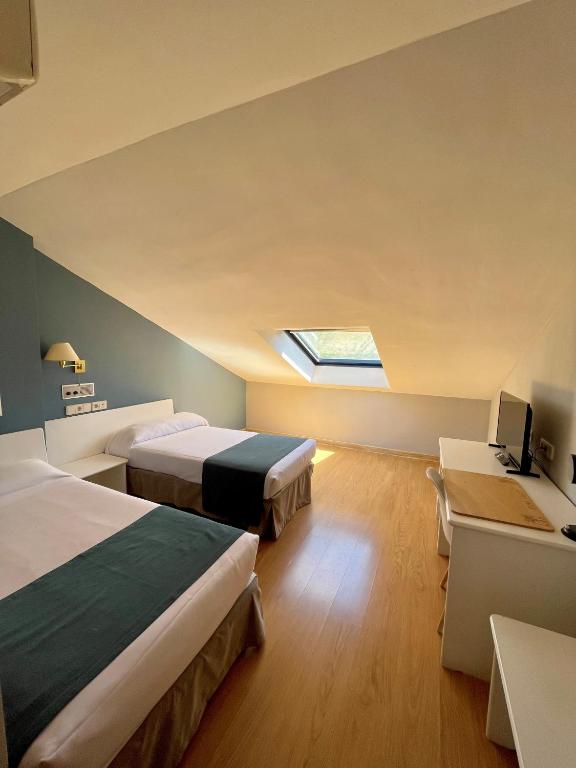 Postel nebo postele na pokoji v ubytování Hotel Jakue