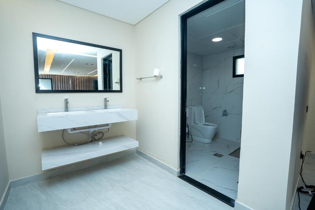 bagno con lavandino, specchio e servizi igienici di Farm Al Medfek a Ras al Khaimah