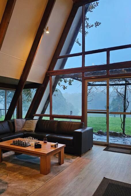 a living room with a couch and a table at Cherswood Farm in Balbarrup