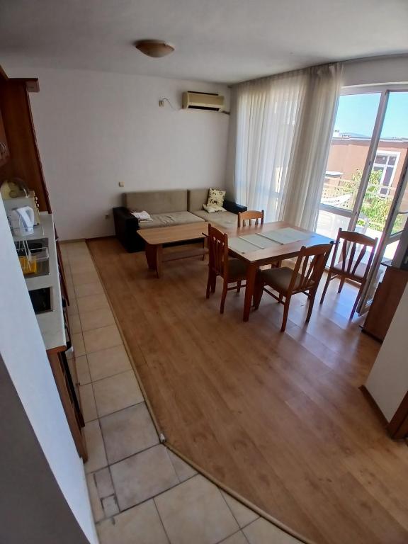 a living room with a table and chairs and a couch at Levante apartments in Nesebar
