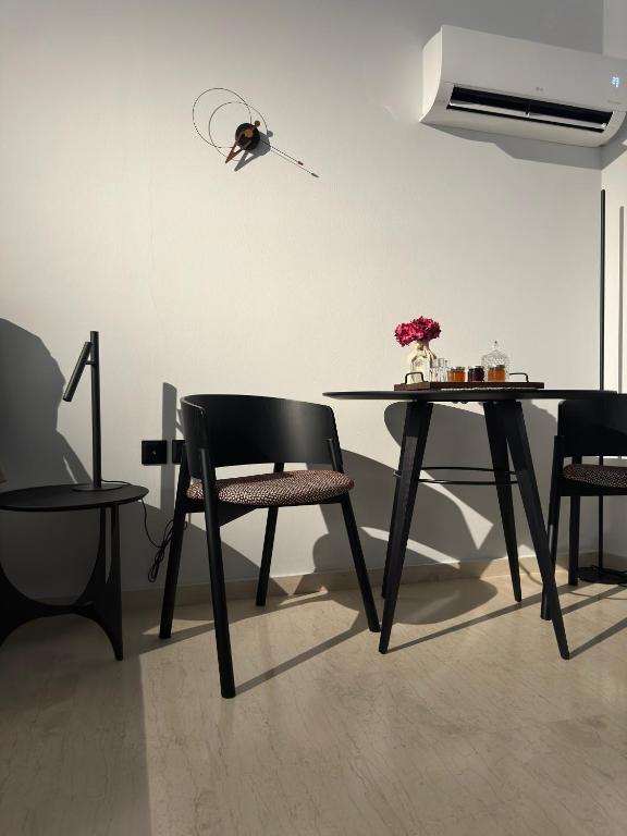 a dining room with a table and two chairs at Libyan Sea Suites in Ierápetra