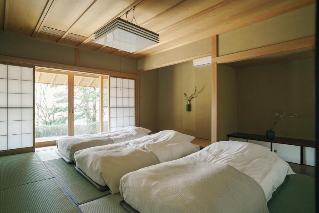 Postel nebo postele na pokoji v ubytování 赤城宿 珠蕾山荘-shurai-