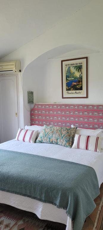 a bedroom with a large bed with a red headboard at Georgesville in Marbella