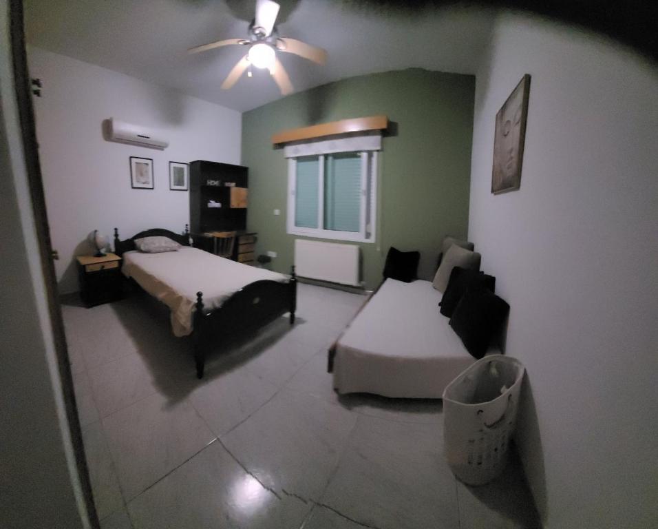 a living room with two beds and a couch at Beautiful bedroom in Limassol