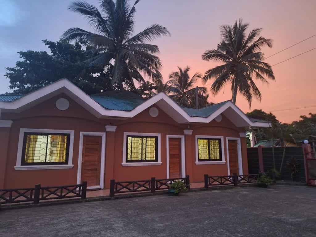 a house with a sunset in the background at Japitan Waterfront Resort in Dolores