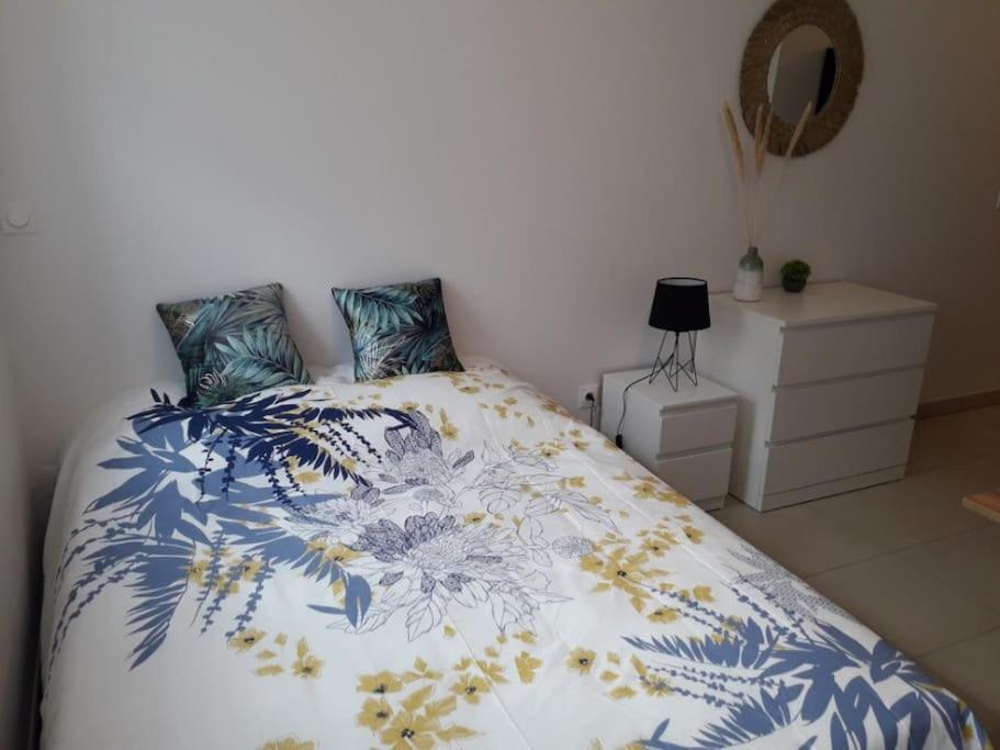 une chambre avec un lit avec une couverture bleue et blanche dans l'établissement Louthalia Congrès centre ville, à Reims