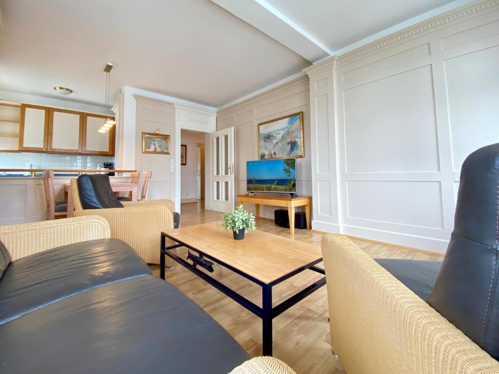 a living room with couches and a table at Villa Usedom App. 31 in Heringsdorf