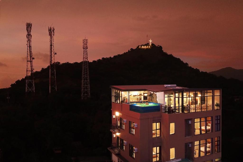 a building at night with a hill in the background at GHIELLANIQA INN in San Nicolas