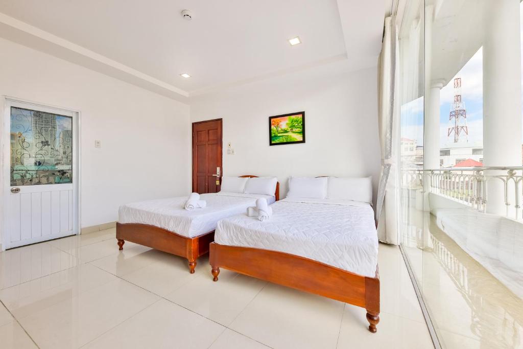 Giường trong phòng chung tại Mangolia Hotel