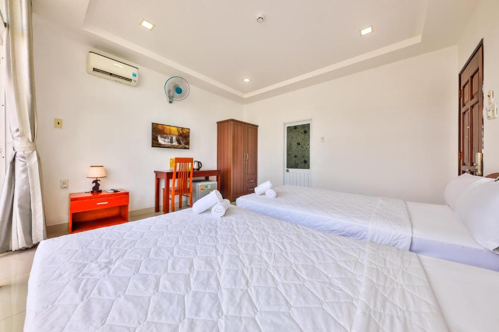 Giường trong phòng chung tại Mangolia Hotel