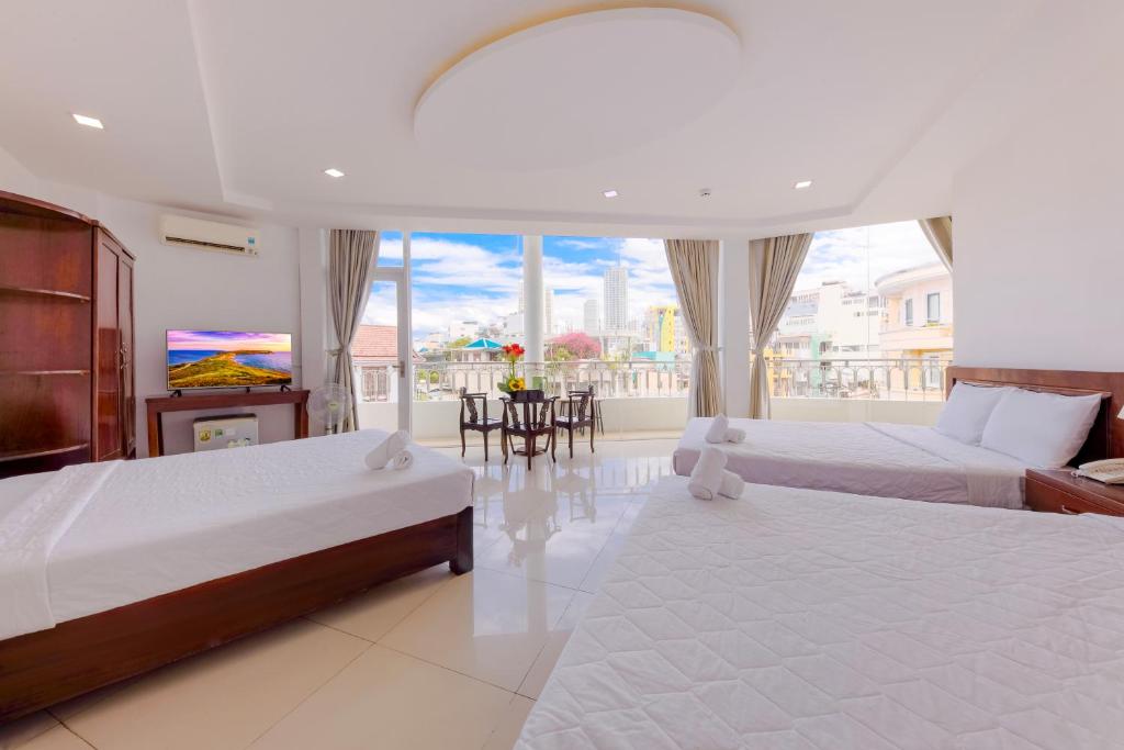 Giường trong phòng chung tại Mangolia Hotel