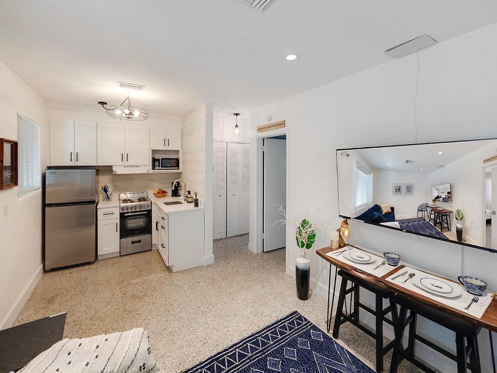 a kitchen and living room with a table in it at Seas the Day 1BR, Next to the Beach in West Palm Beach