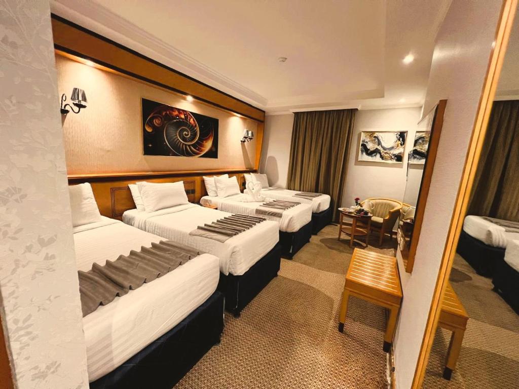 Postel nebo postele na pokoji v ubytování Maysan Al Maqam Hotel