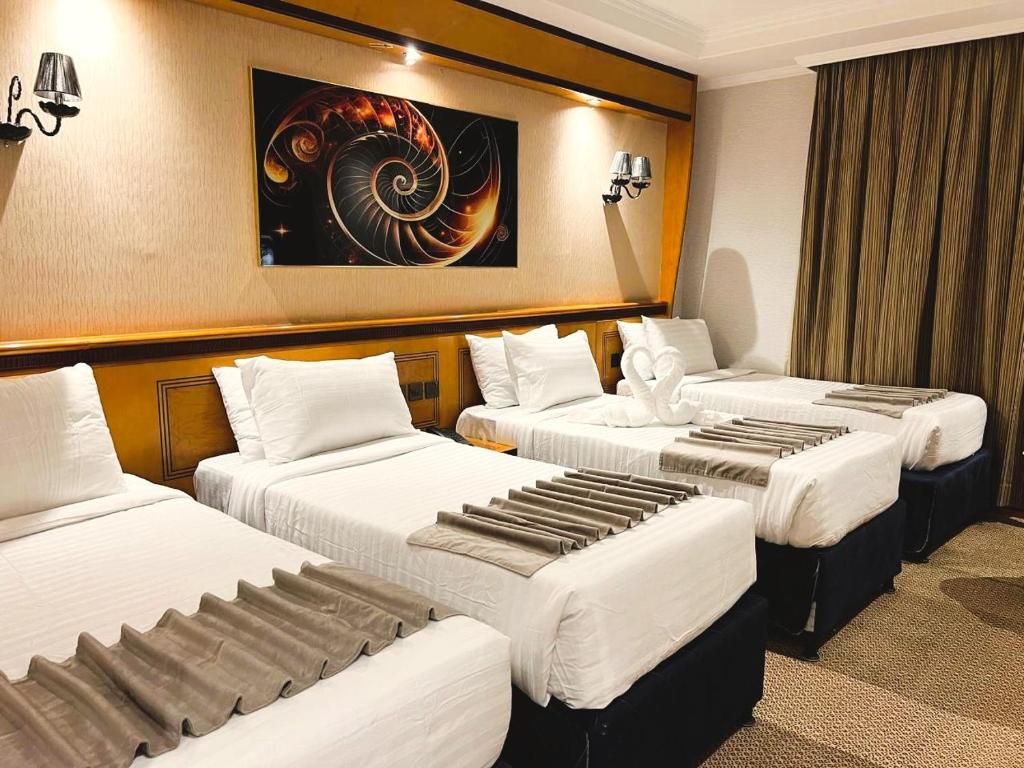 Postel nebo postele na pokoji v ubytování Maysan Al Maqam Hotel