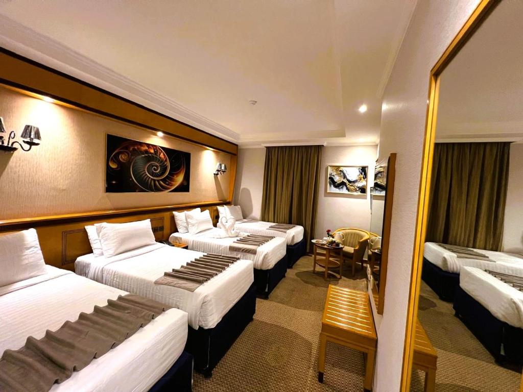 Postel nebo postele na pokoji v ubytování Maysan Al Maqam Hotel