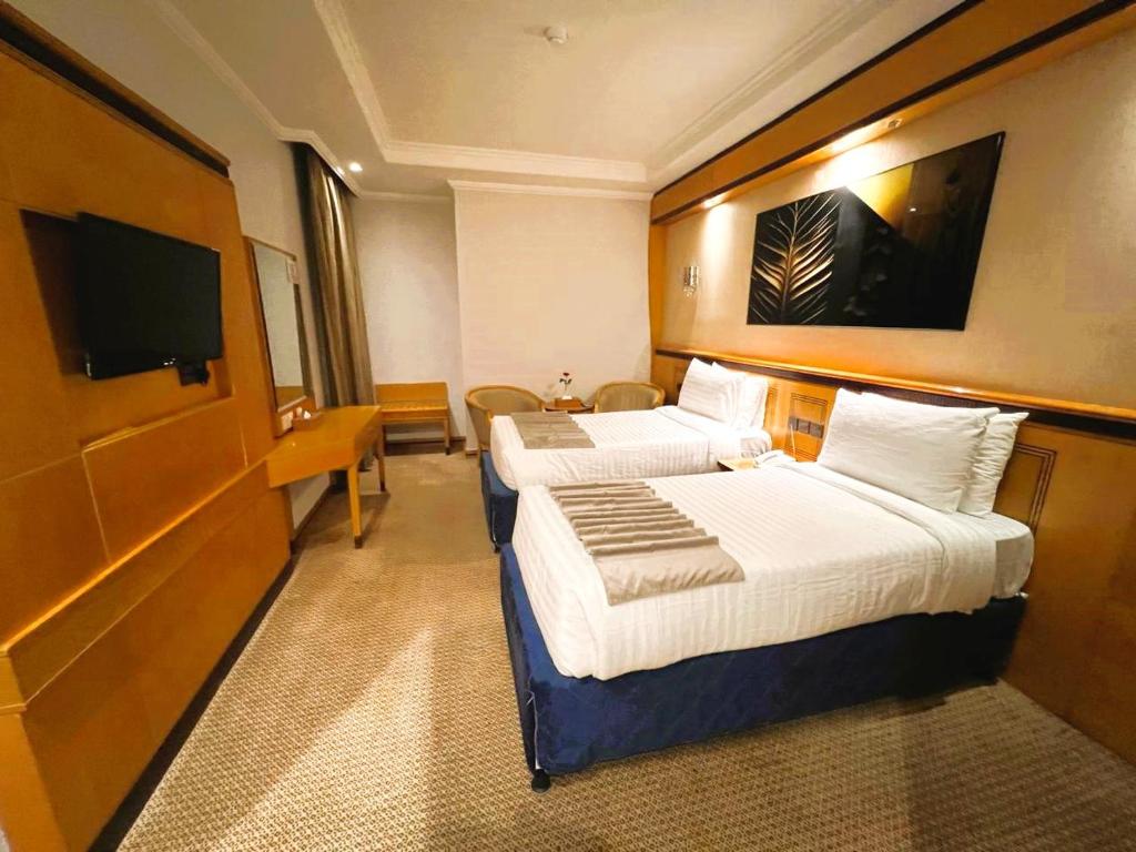 Postel nebo postele na pokoji v ubytování Maysan Al Maqam Hotel