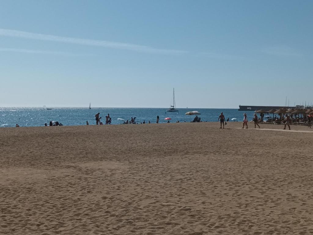 a group of people walking on a beach at Mediterranean vibes in Málaga