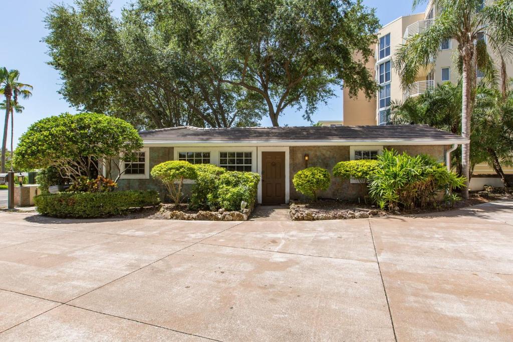 a house with a driveway in front of a building at Coastal Dream Beach House in Clearwater Beach