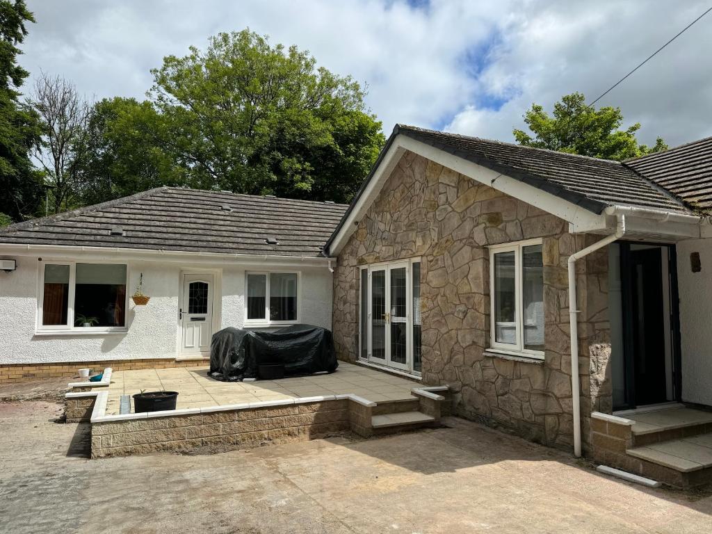 a house with a patio in front of it at Woodlands House in Alexandria