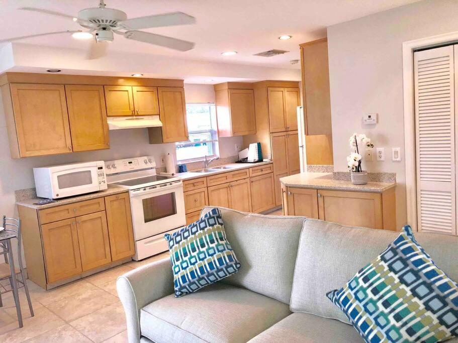 a living room with a couch and a kitchen at Goodland Waterfront Cottage in Goodland