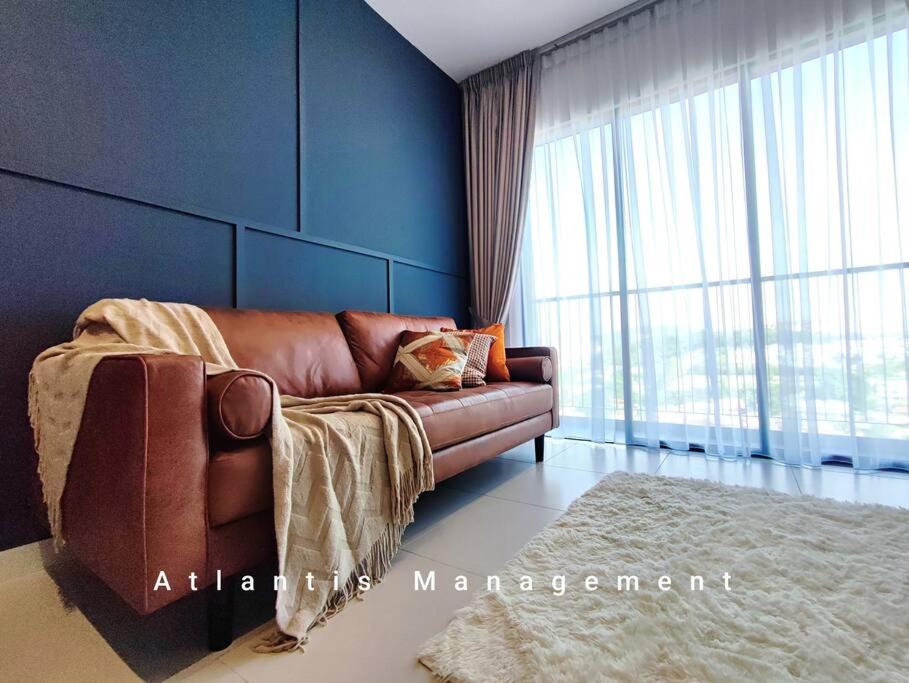 a living room with a couch and a large window at Sungai Besi, Uno Promenade, Nearby Bukit Jalil & Salak Selatan MRT by Atlantis Management in Kuala Lumpur