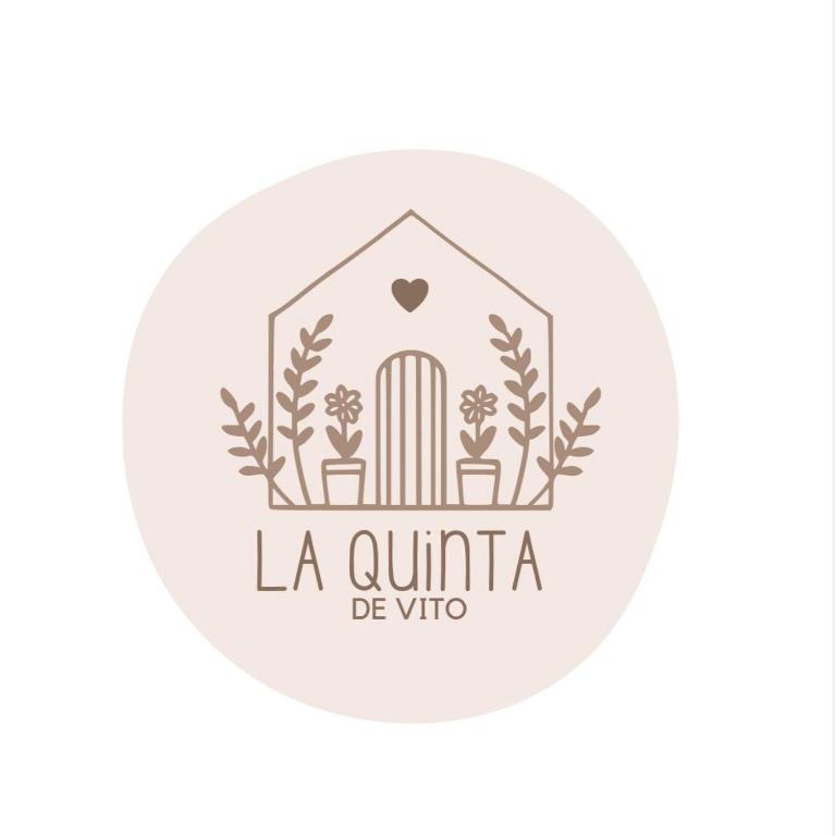 a logo for a villa with a gate and plants at La quinta de Vito in San Pedro