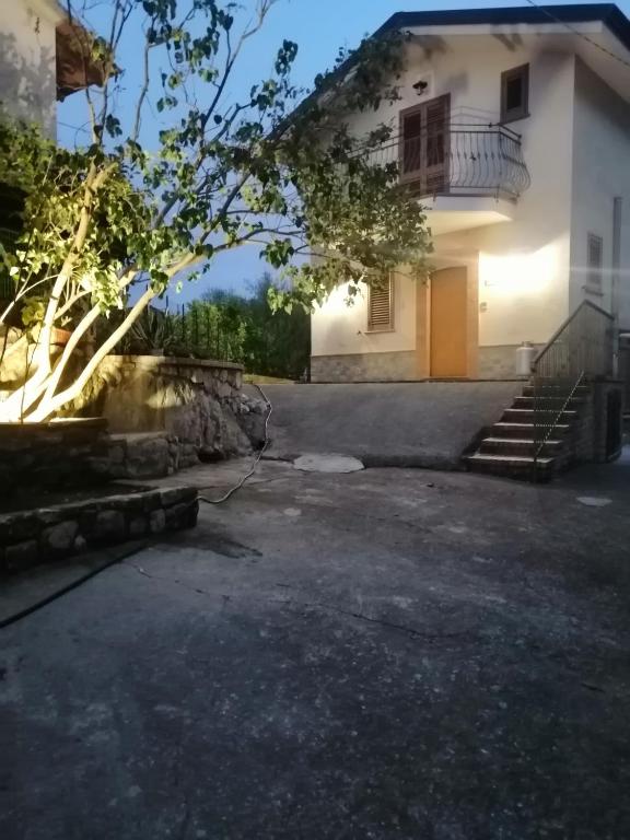 a house with a staircase in front of it at Al Carpine in Roccadaspide