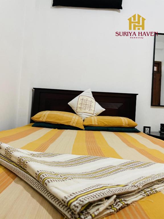 a bedroom with a bed with a large bed frame at Suriya Haven Homestay in Badulla