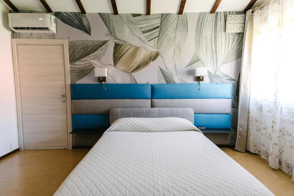 Łóżko lub łóżka w pokoju w obiekcie B&B Spina Verde