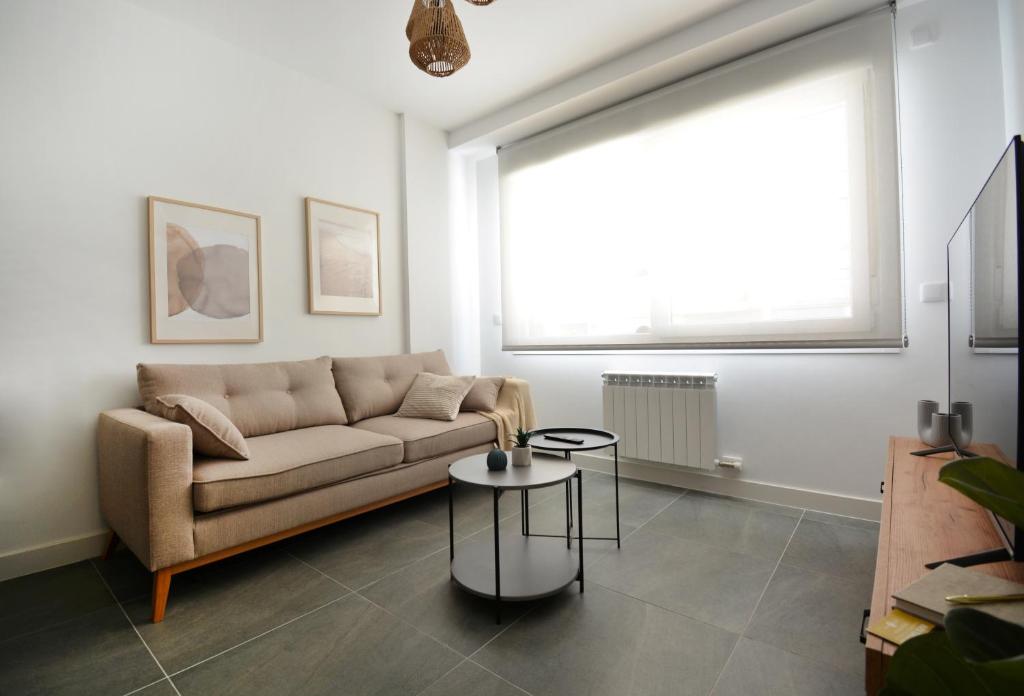 a living room with a couch and a table at GALIHOST - Apartamento en Playa de Compostela in Vilagarcia de Arousa