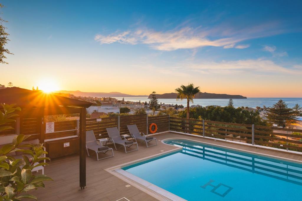a pool on a balcony with a view of the ocean at Seaview Garden Villa - Heated Pool & Sauna in Stalos
