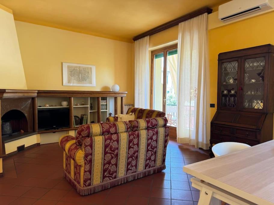 a living room with a couch and a table at Giardino Concordia Apartment in Lucca