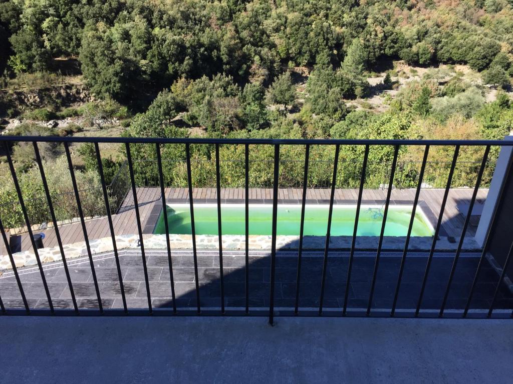 a view of a pool from a balcony at Saint Christophe in Omessa