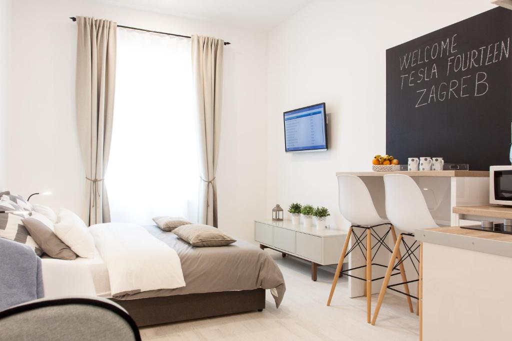a bedroom with a bed and a desk at Tesla Boutique Apartments & Rooms in Zagreb