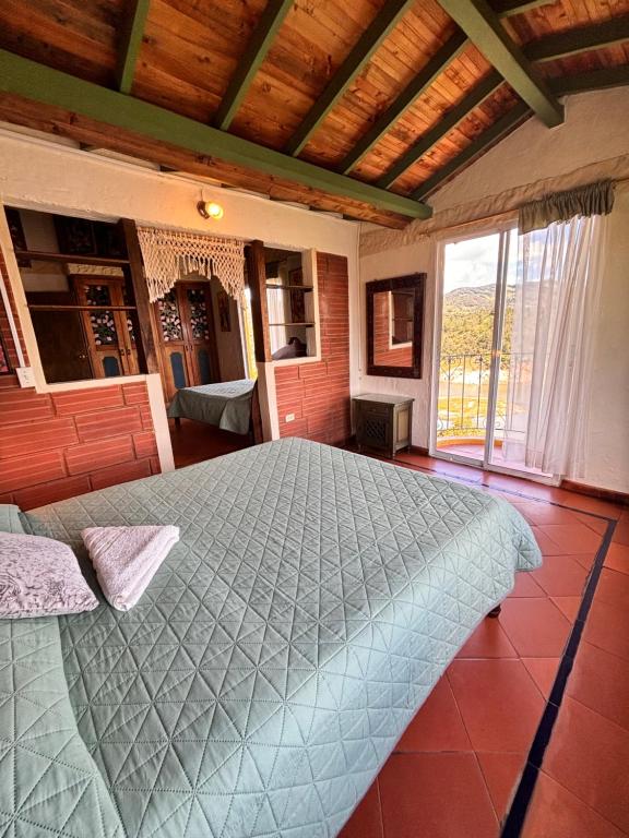 a bedroom with a large bed in a room at Casa Encuentro Ecolodge, Outdoor Gym and Yoga in Guatapé