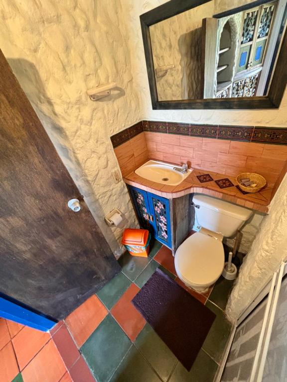 a small bathroom with a toilet and a sink at Casa Encuentro Ecolodge, Outdoor Gym and Yoga in Guatapé