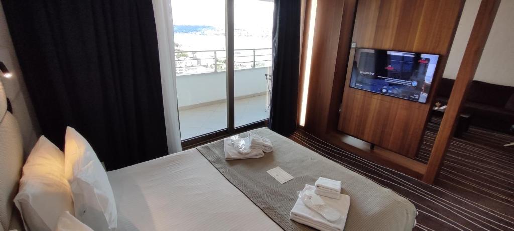 a hotel room with a bed and a television at Cihangir Hotel Bosphorus in Istanbul